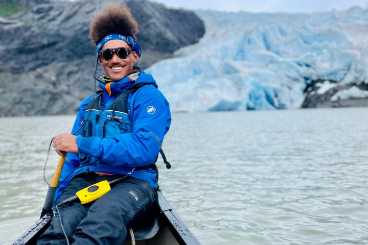 a person sitting next to a body of water
